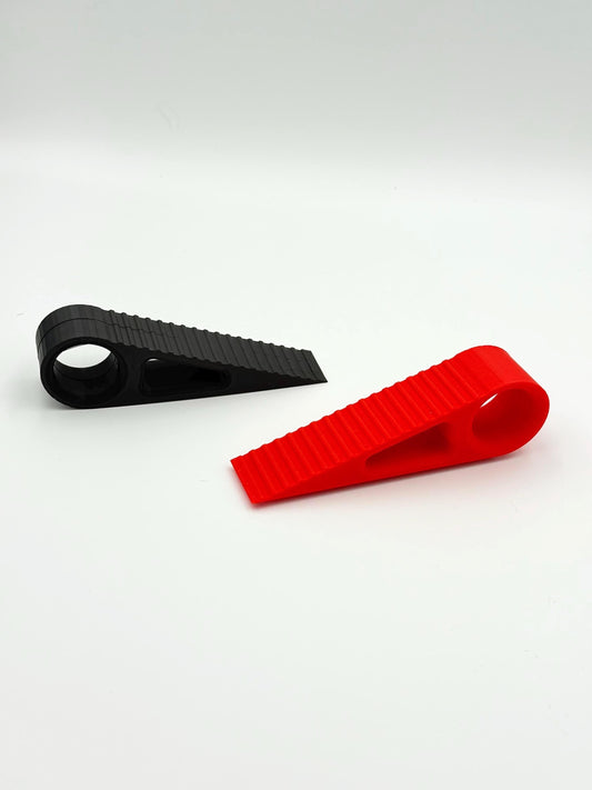 Wedge door stop, non-slip plastic, durable, compact, ideal for home/office, enhances security, stabilizes doors effectively.